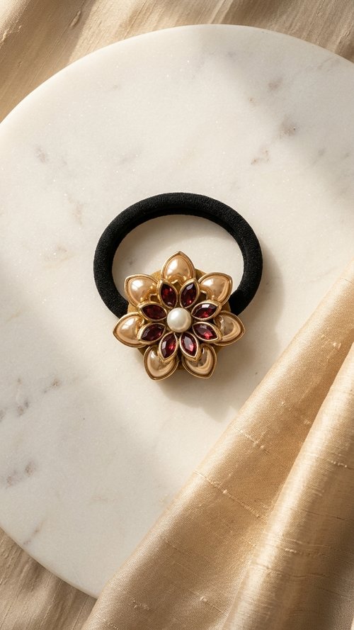 Decorative hair tie with floral design on a marble surface Antique Burgundy Petal Kundan Hair Tie