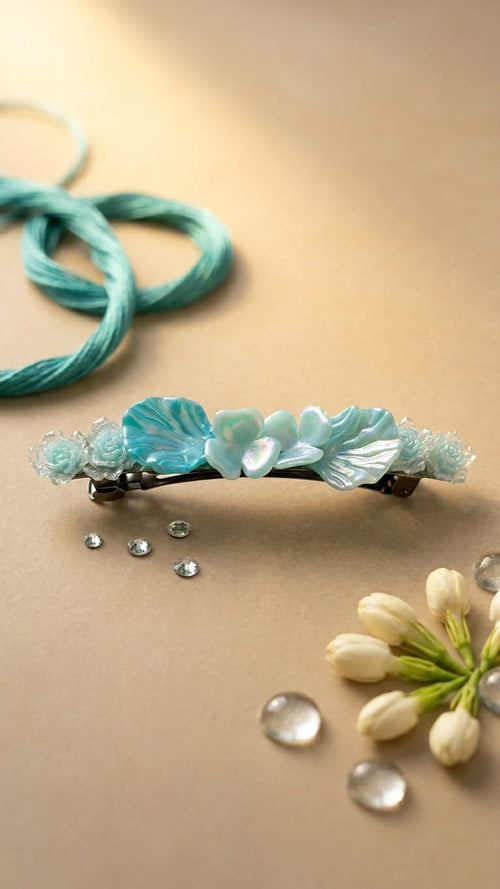 Decorative hair barrette with floral design on a beige surface with flowers and beads.
Aqua Lumina Sea-Ripple Floral Brooch